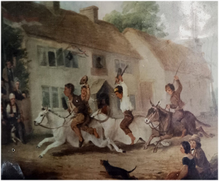 A painting of the original Black-a-Moors Head Pub (c1847). This was on an annual ‘Club Day’ event and on the occasion a donkey race took place. Seen seated at the front far left is Mr & Mrs Bennet Lowe (Landlord and Landlady) with their dog ‘Paddy’ seen at the Landlords feet.